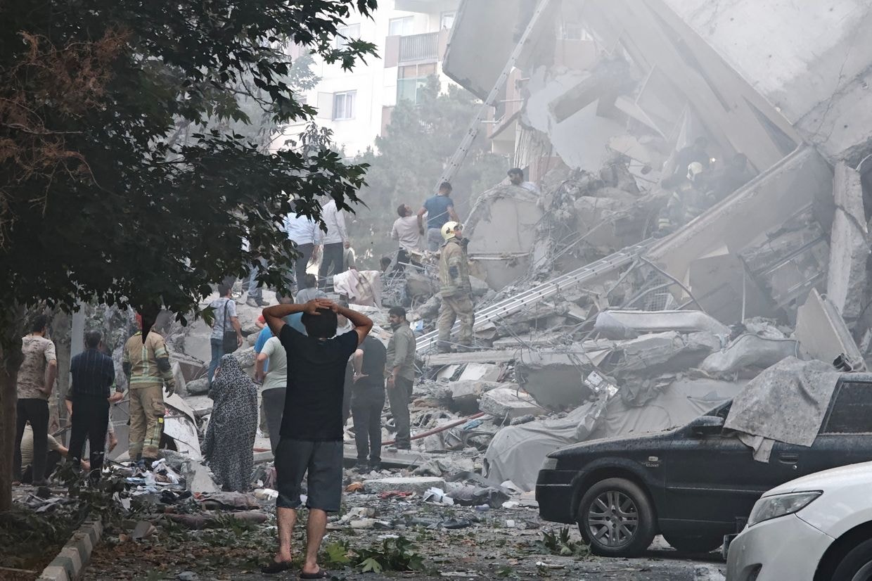 People look over damage to buildings in Nobonyad Square following Israeli airstrikes in Tehran, Iran, on June 13, 2025. 