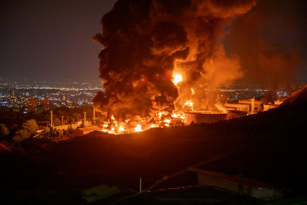Fire and smoke rise into the sky after an Israeli attack on the Shahran oil depot in Tehran, Iran, on June 15, 2025.
