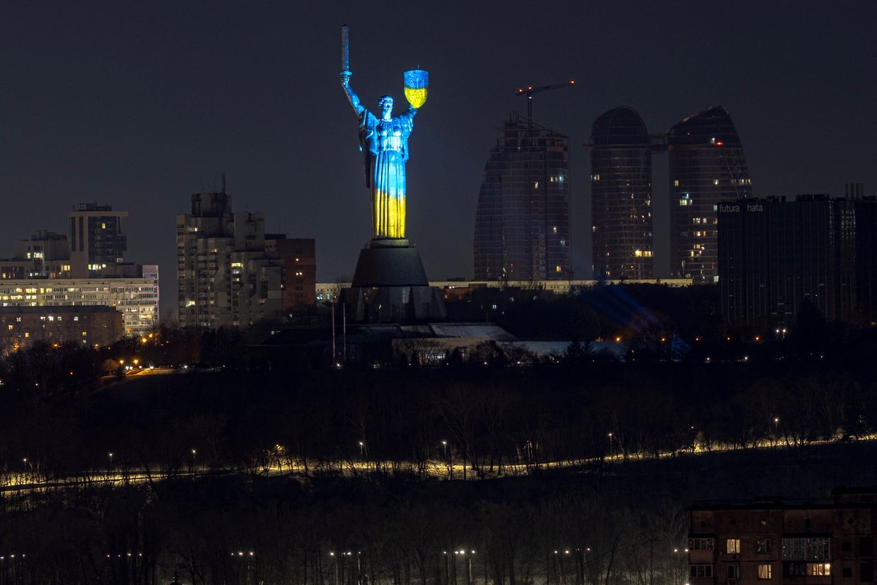 The colors of Ukraine’s flag illuminate the Motherland Monument at night in Kyiv, Ukraine, on Feb. 24, 2025.