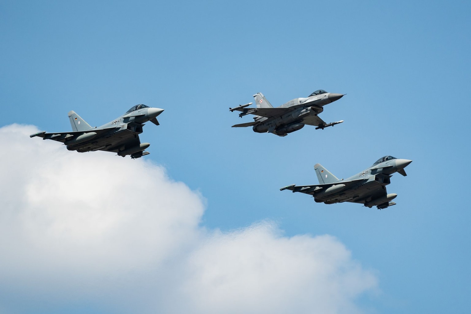 A Polish F-16 and two Eurofighter Typhoon jets during the Polish Army Parade in Warsaw, Poland, on Aug. 15, 2025. (Damian Lemanski/Bloomberg via Getty Images)