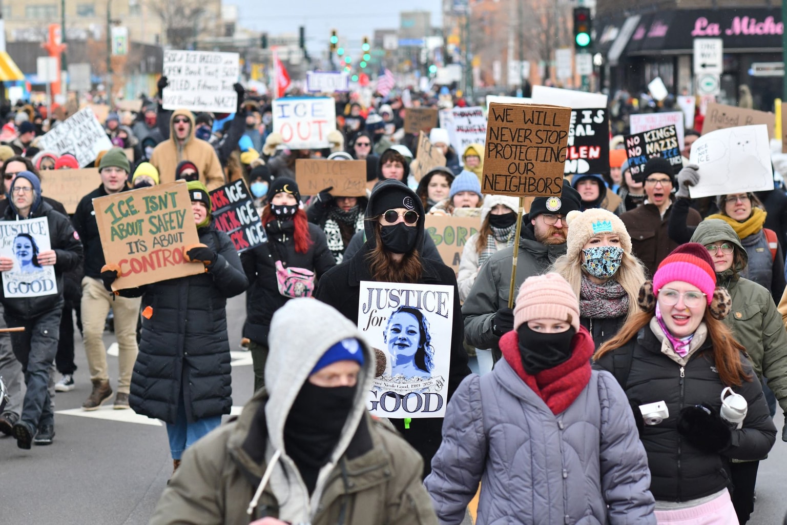 Protesters hold signs and march from Powderhorn Park in Minneapolis, Minnesota, on Jan. 10, 2026