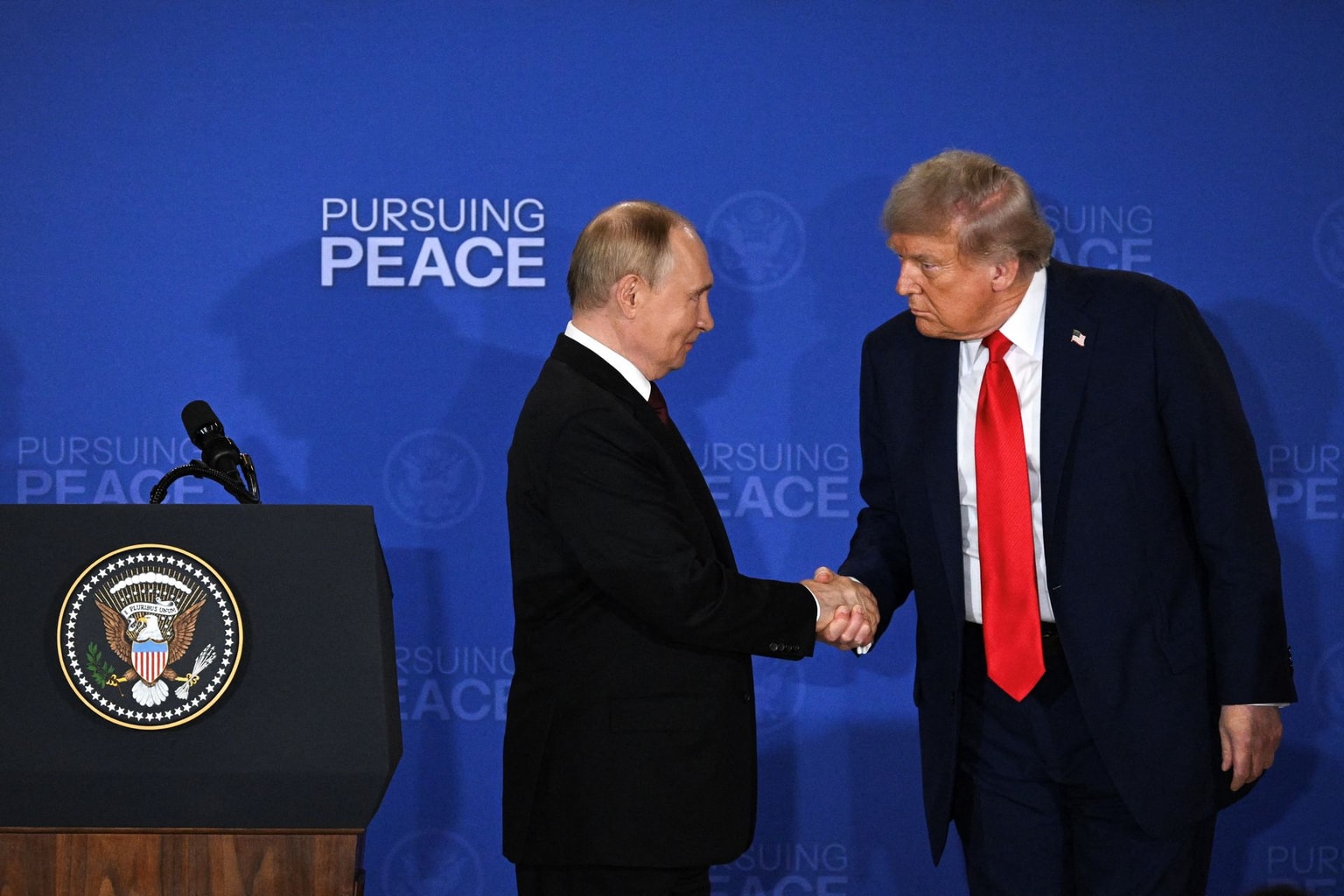 Trump (R) and Putin (L) shake hands at the end of a U.S.-Russia in Anchorage, Alaska, U.S. on Aug. 15, 2025.