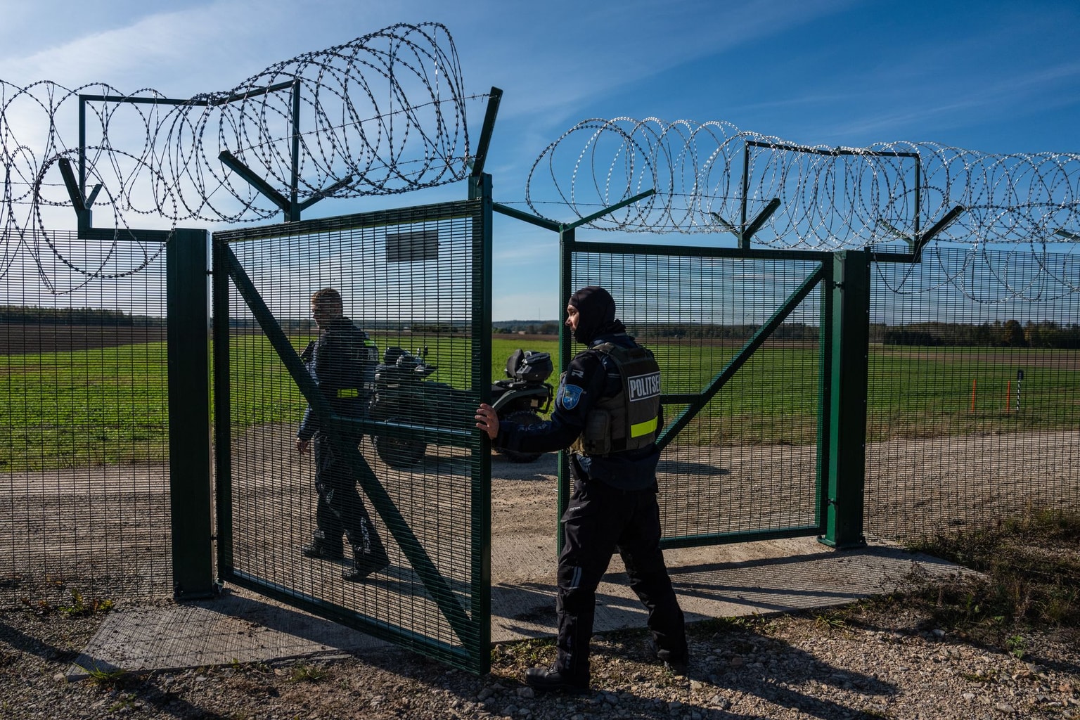 Estonian border police officers pass through a gate on the Estonian-Russian border in Vinski, Estonia, on Oct. 1, 2025. 