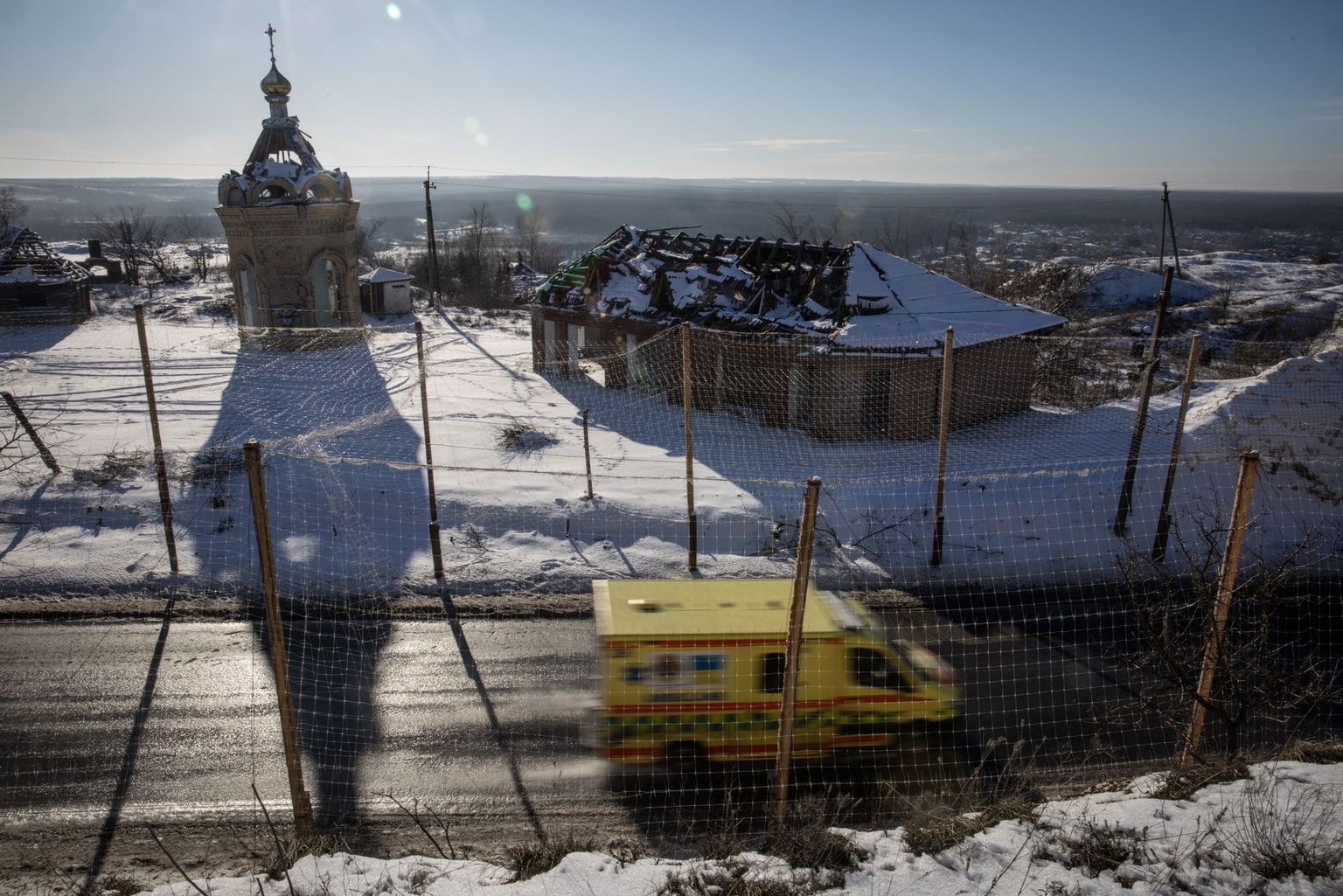 An ambulance car on a road covered in anti-drone netting in Izium, Kharkiv Oblast, Ukraine, on Feb. 22, 2026.
