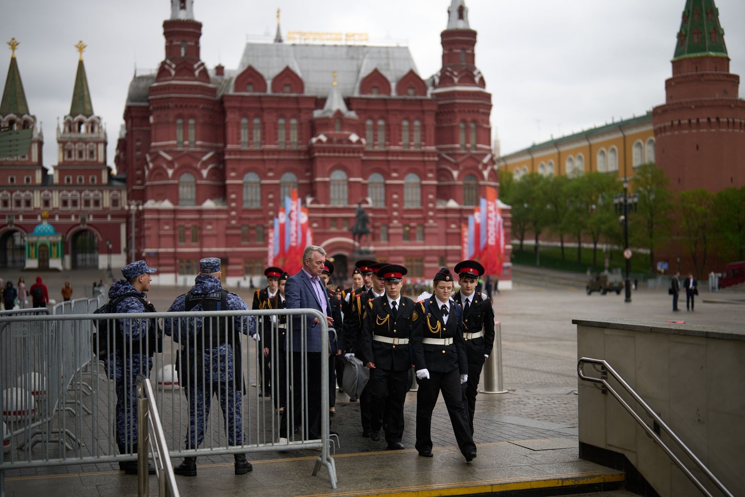 Russian cadets walk past police guarding Manezhnaya Square in Moscow, Russia, on May 8, 2026.