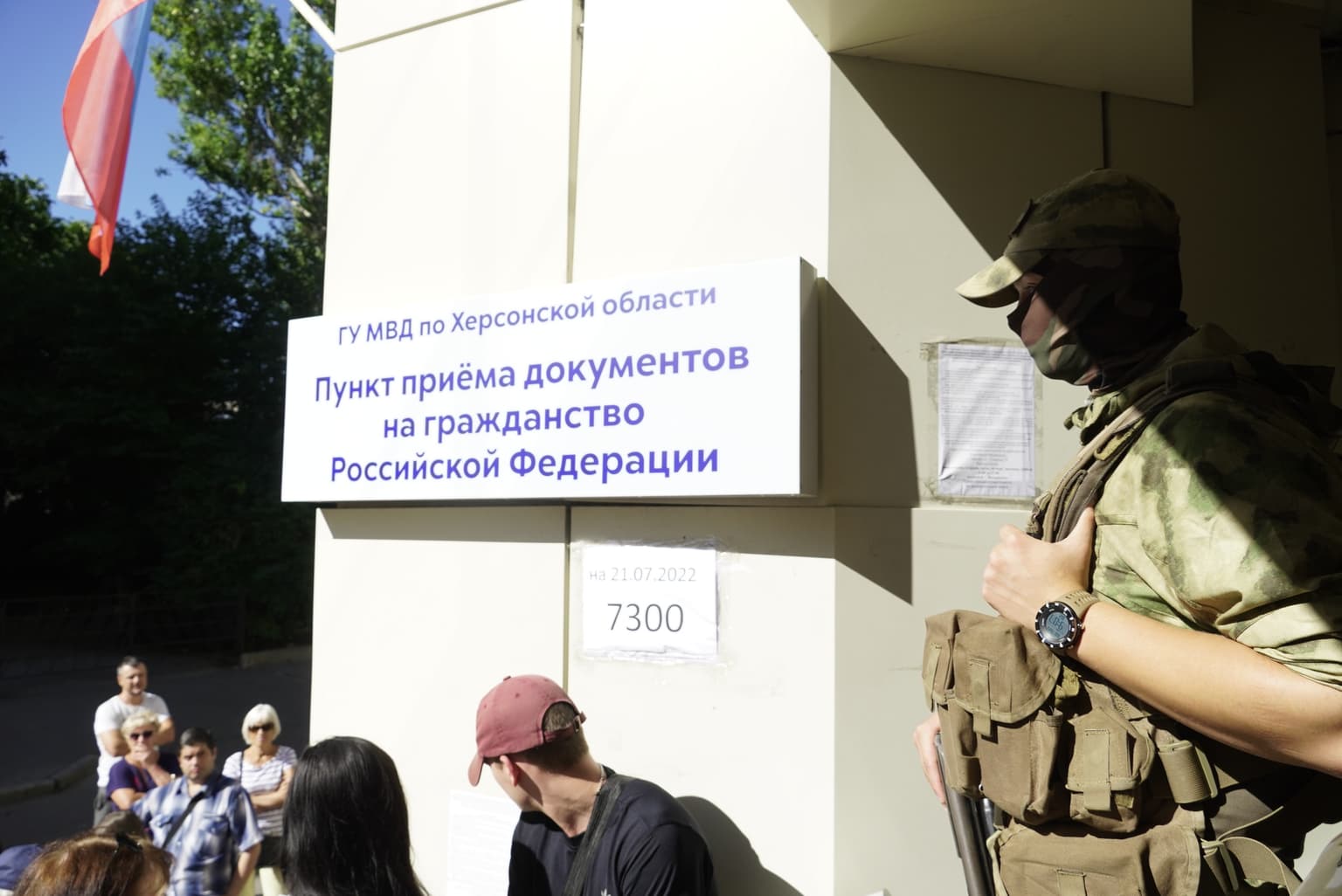 People arrive to receive Russian passports at a center in Russian-occupied Kherson on July 21, 2022