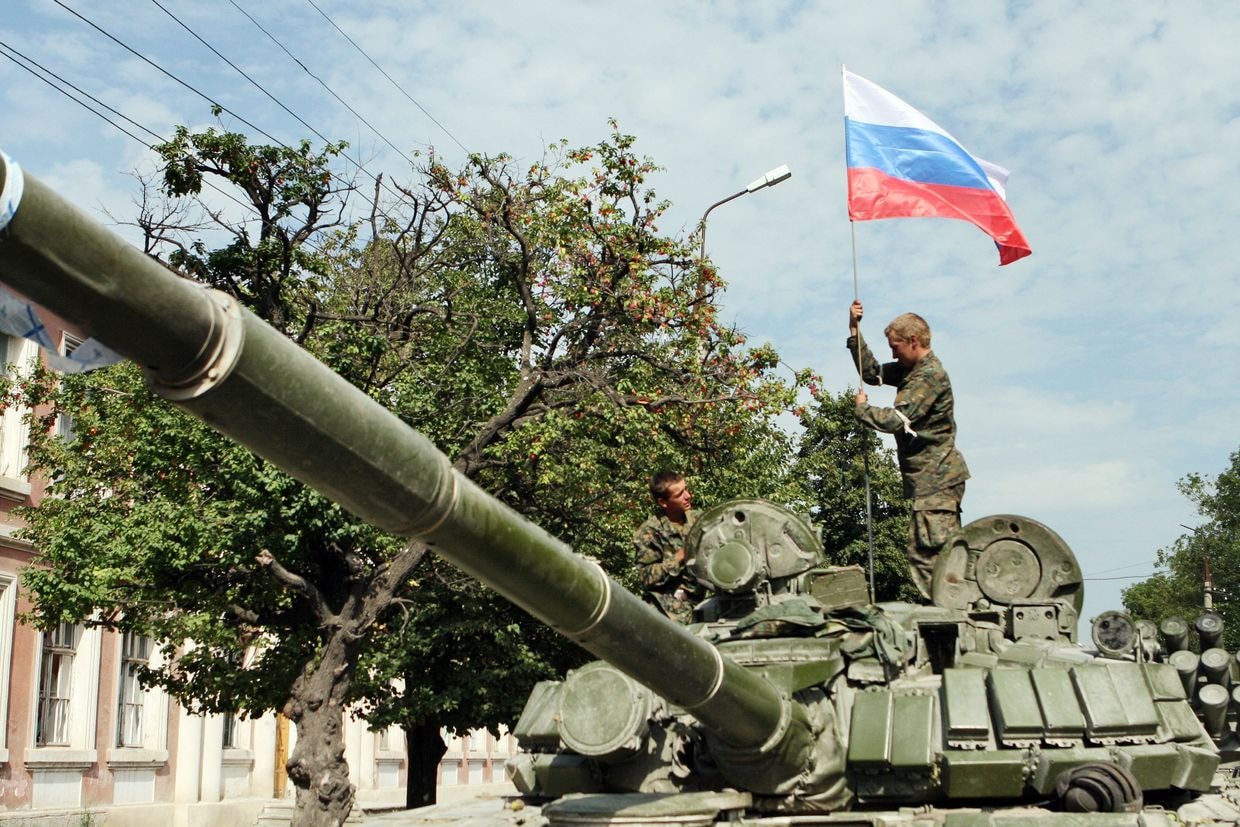 Russian soldiers place a Russian flag atop their tank in Tskhinvali, Georgia on Aug. 11, 2008.