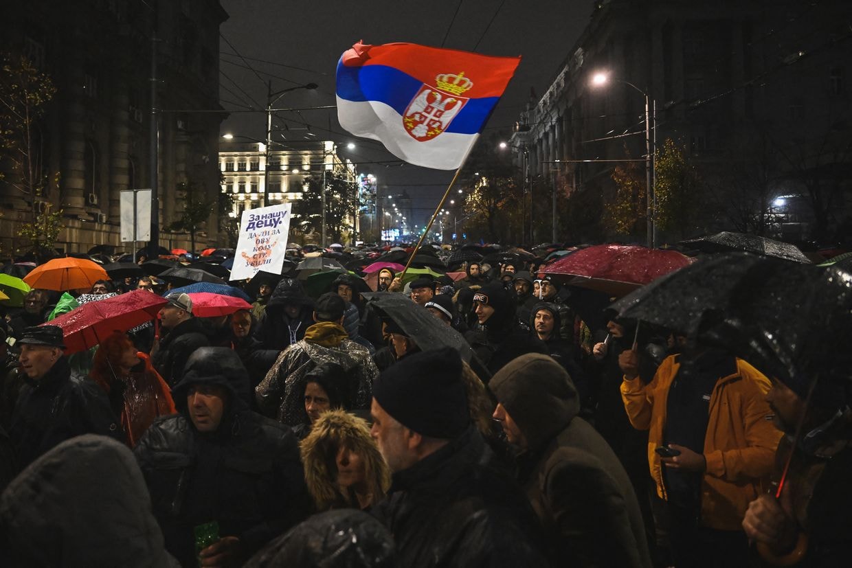 A man waves a Serbian flag during a protest demanding Milos Vucevic's resignation in Belgrade, Serbia, on Nov. 11, 2024.