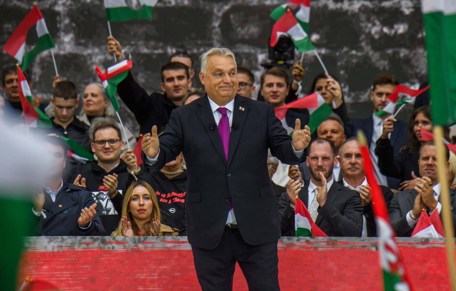 Hungarian Prime Minister Viktor Orban is applauded by his supporters in front of the Hungarian Parliament in Budapest, Hungary, on Oct. 23, 2025.