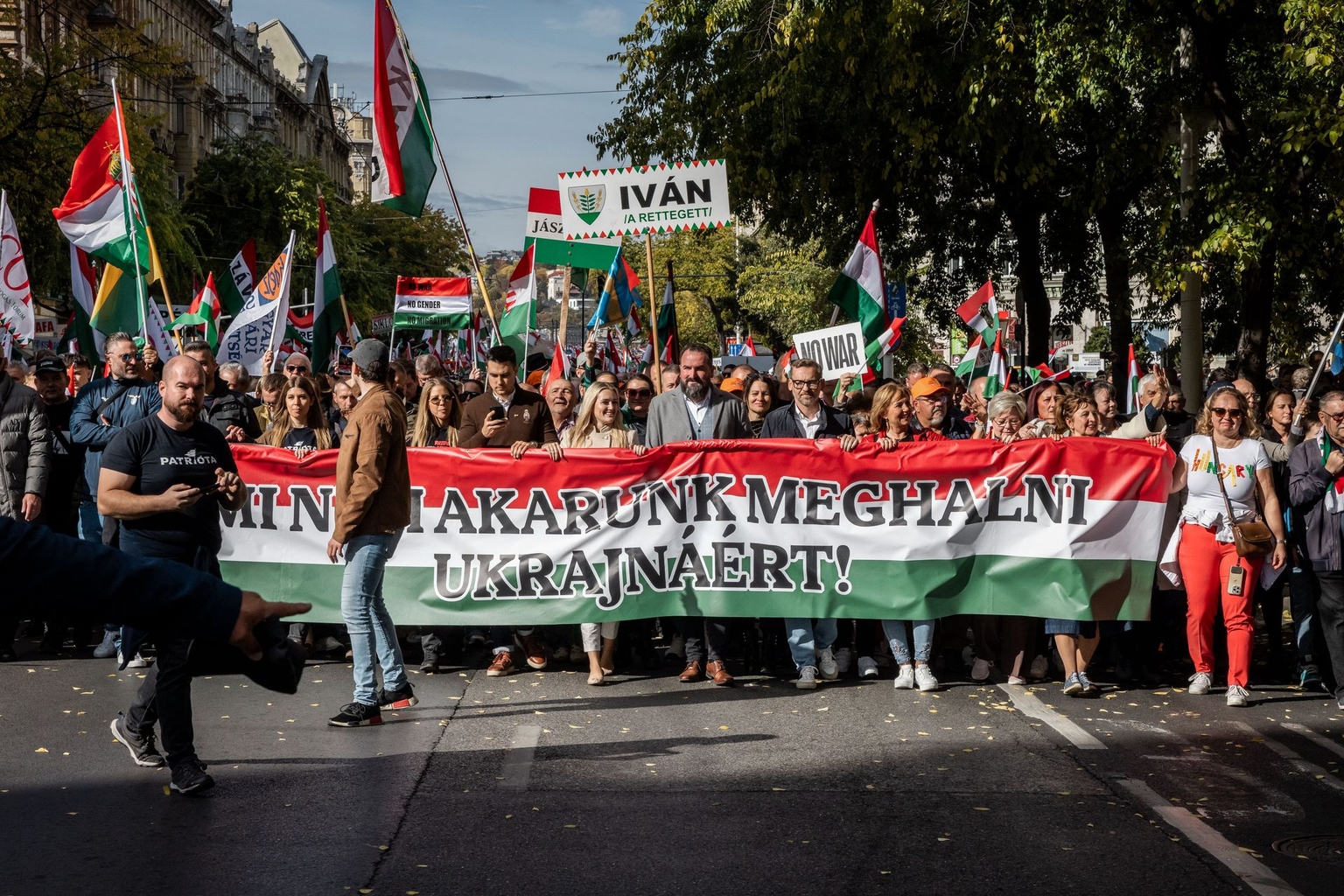 Supporters of the Fidesz party hold placards and flags during a peace march called “Bekemenet” in Budapest, Hungary, on Oct. 23, 2025.