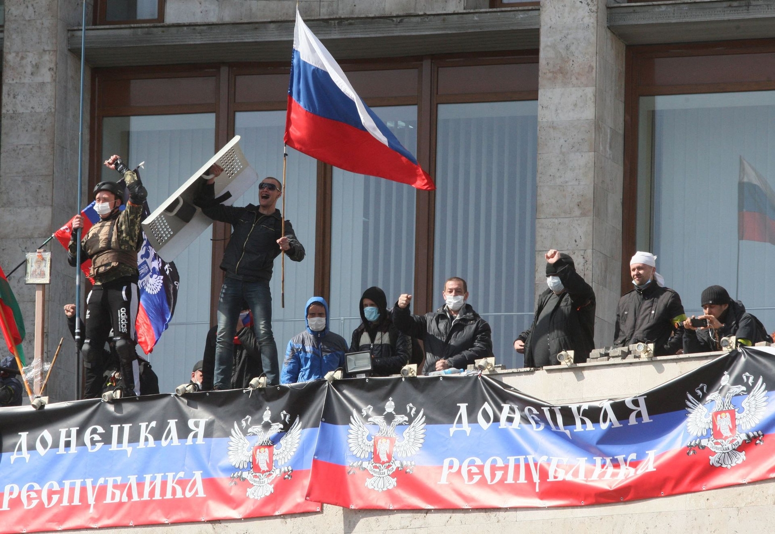 Russia-backed separatists who seized the main administration building of the city, with a flag of the so-called Donetsk Republic and Russian flag in Donetsk, Ukraine on April 7, 2014.
