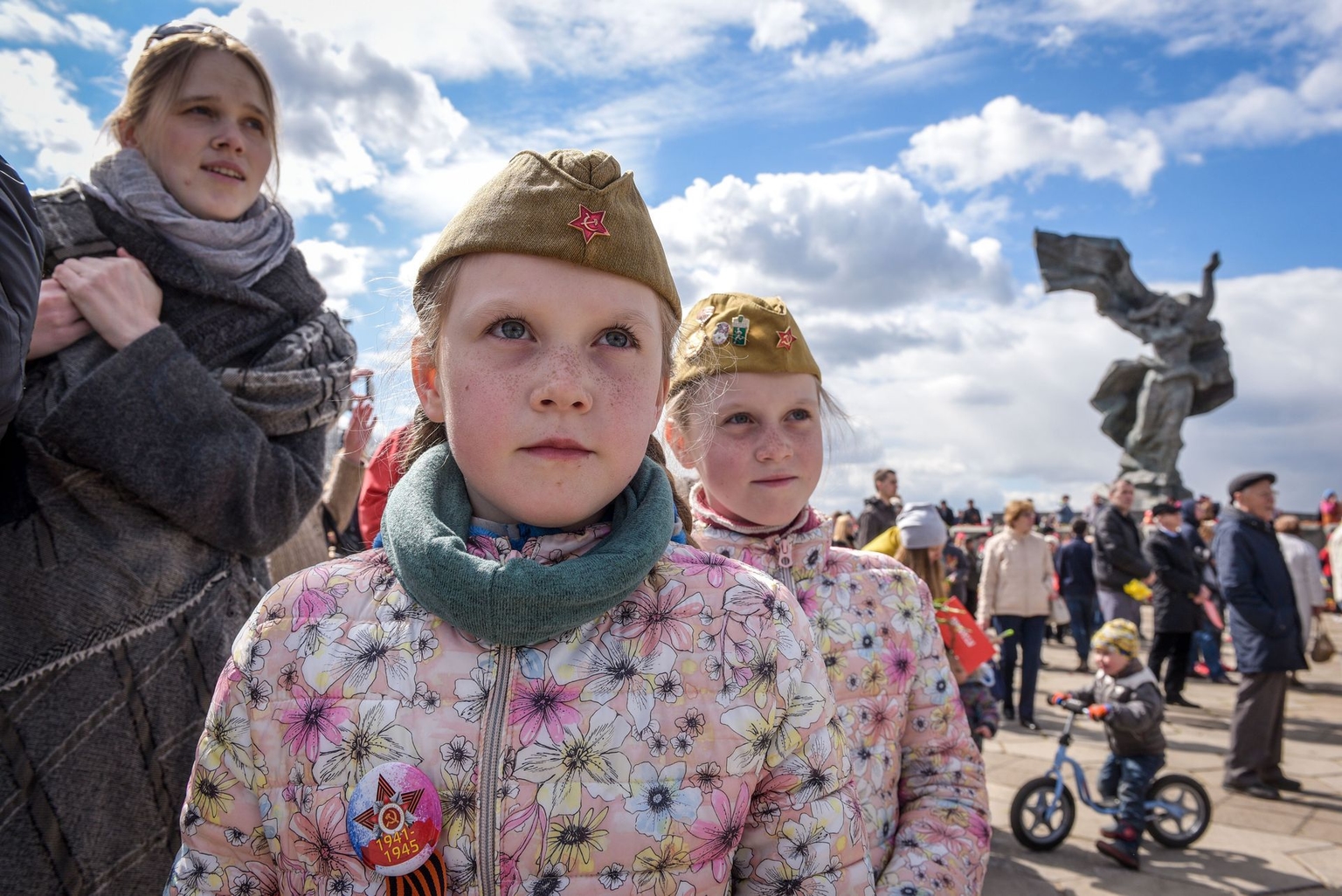 Two girls attend festivities near Victory Monument to the Soviet Army in Riga, Latvia, on May 9, 2017.