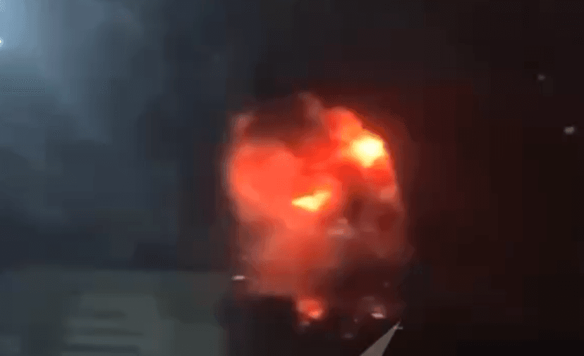 A fiery explosion under a dark sky