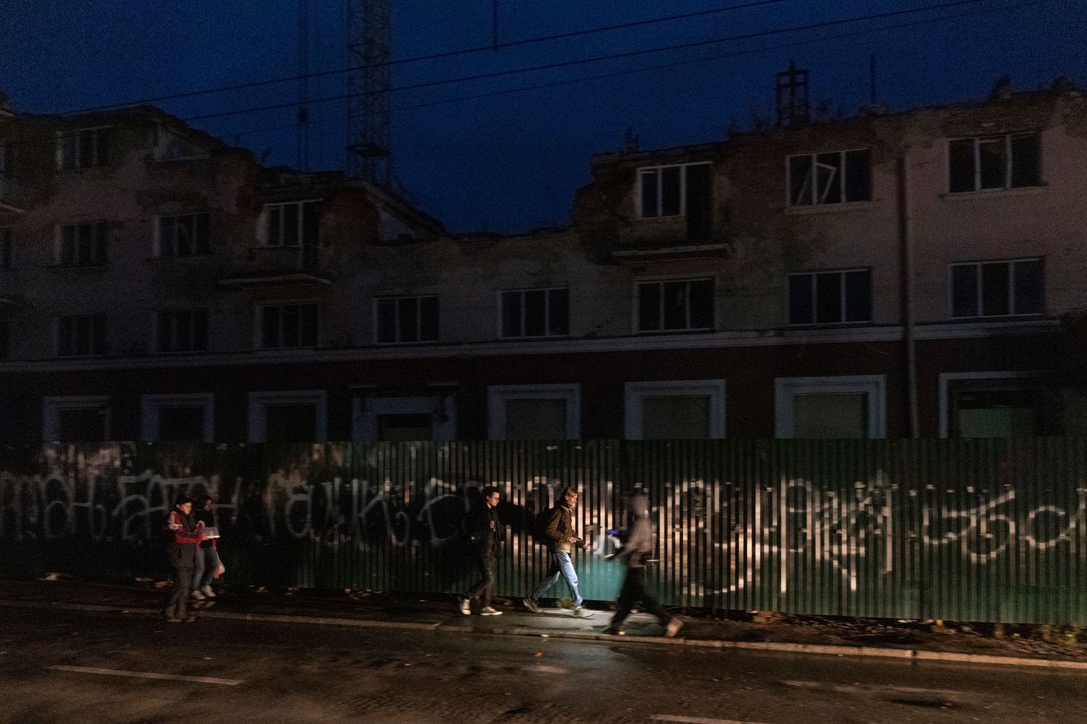 Local residents walk through the city center during a blackout in Chernihiv, Ukraine, on Oct. 10, 2025.