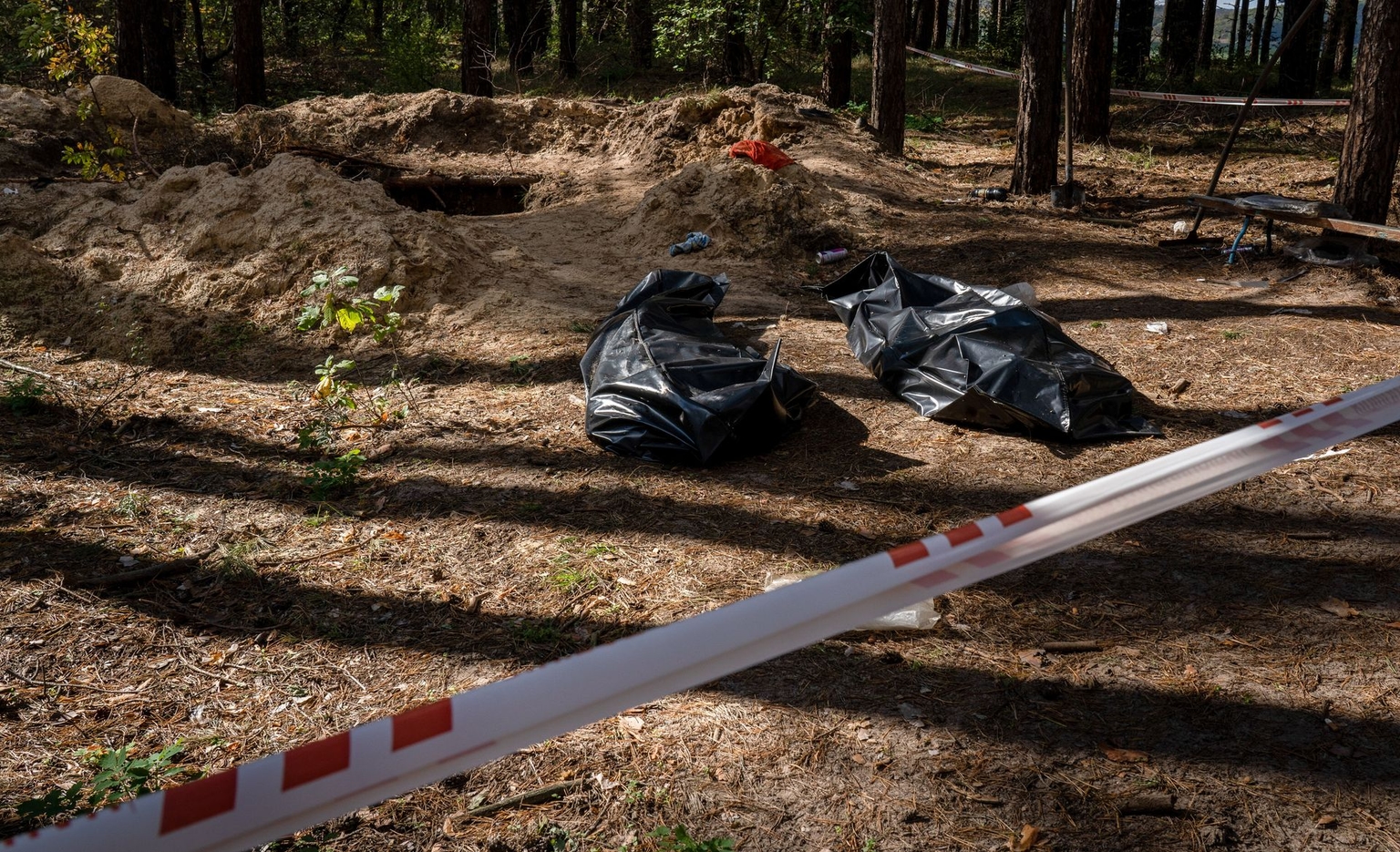 Two bodies are found in a pit where people were allegedly held during the Russian occupation in a four-meter-deep hole in Borova, Kharkiv Oblast, Ukraine, on Oct. 7, 2022.