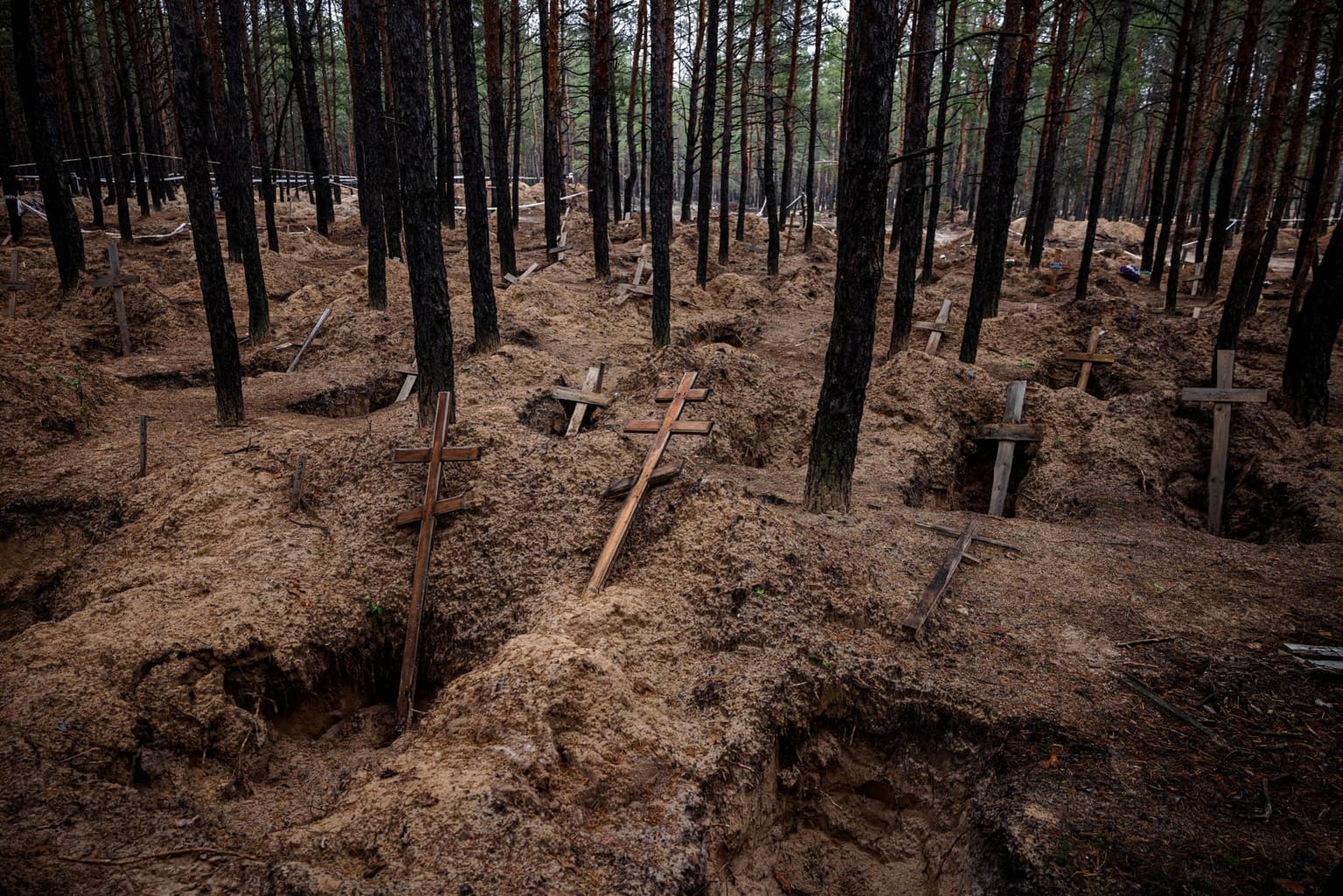 Exhumation of bodies from mass burial sites dug during the Russian occupation of Izium, Ukraine, on Nov. 4, 2022.