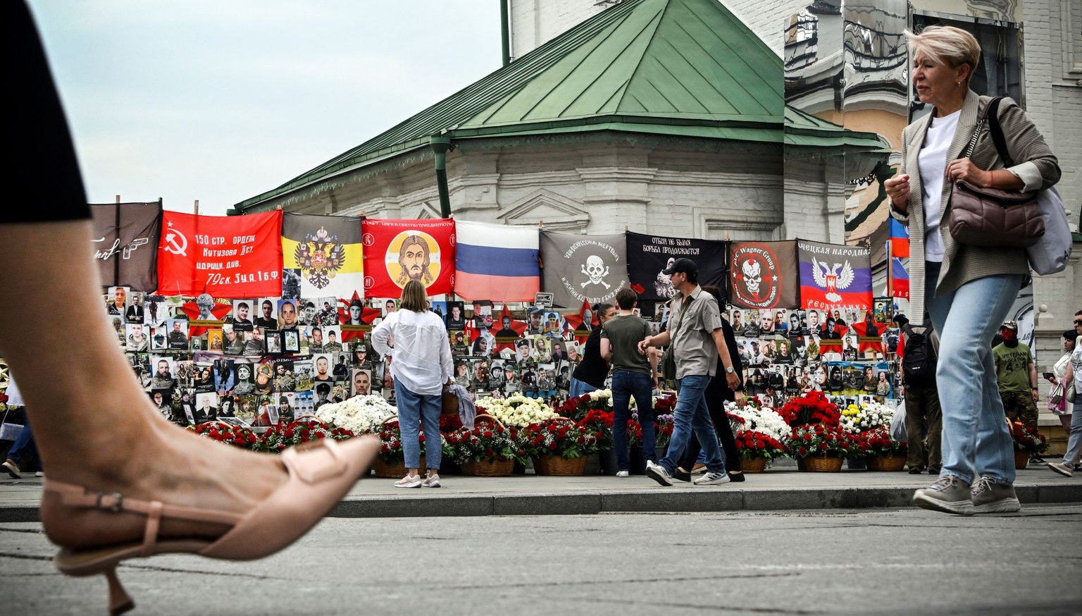 Pedestrians walk past an improvised memorial to fallen Wagner Group fighters in central Moscow, Russia, on Aug. 23, 2024.