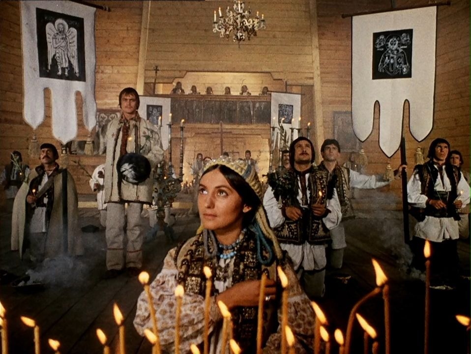 A screen grab from Shadows of Forgotten Ancestors (1965) shows Marichka (C) and Ivan (L) in a church.