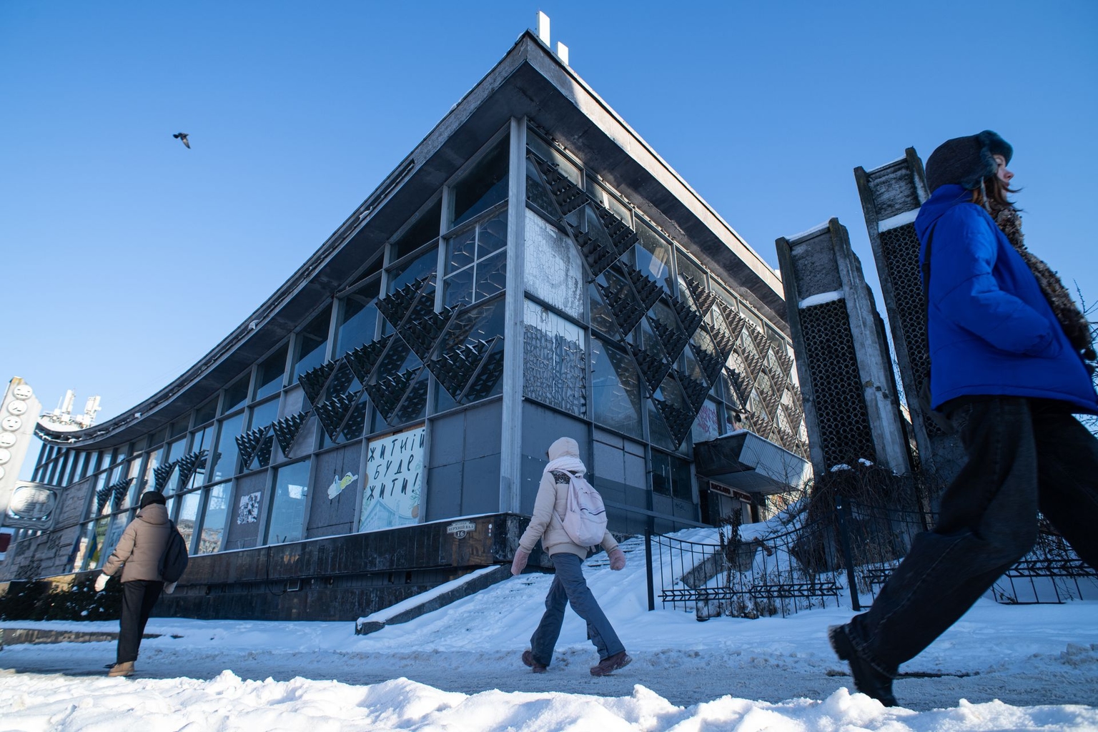 People are seen passing by the building of Zhytniy Market in Kyiv, Ukraine, on Feb. 10, 2026.