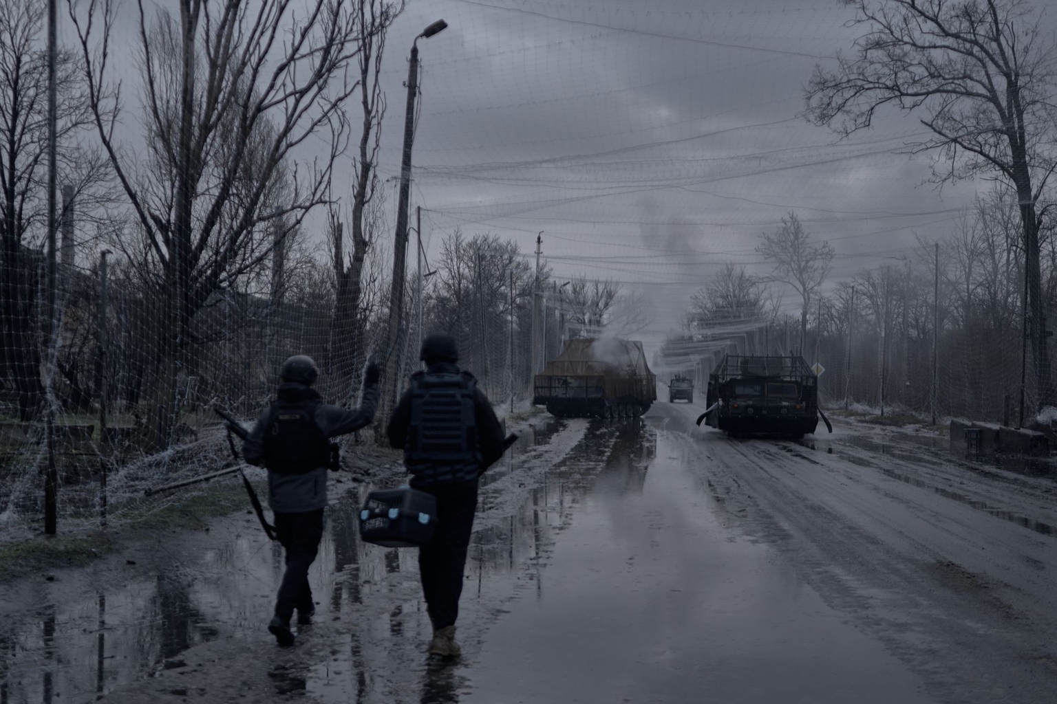 Soldiers walk towards destroyed Ukrainian armored vehicles sitting along the roadside between Druzhkivka and Kostyantynivka, Donetsk Oblast, Ukraine, on Feb. 13, 2026.