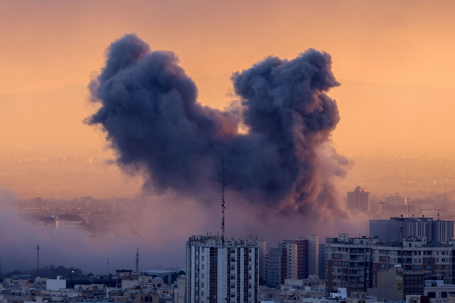 A plume of smoke rises following a strike on Tehran, Iran, on March 3, 2026.