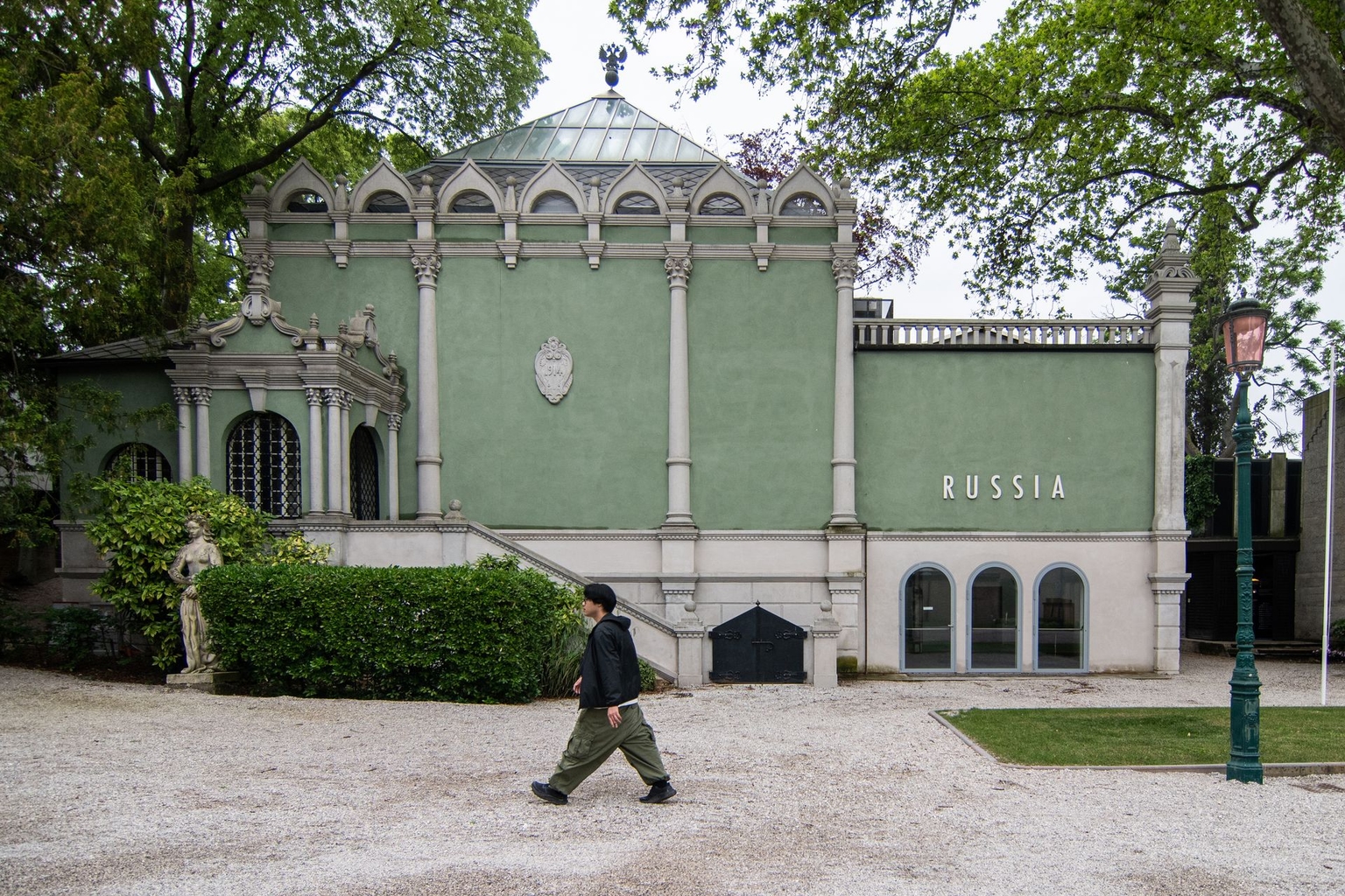 A visitor walks past the closed Russian pavilion in Venice, Italy, on May 17, 2023.