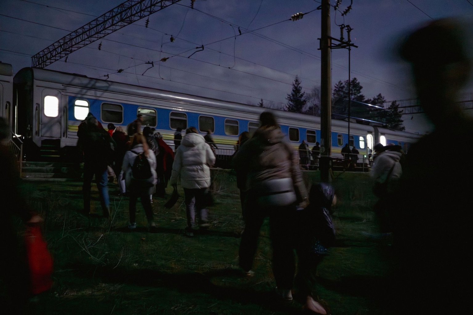 Passengers of the Kharkiv-Vorokhta train return to their carts after a Russian drone attack threat in Poltava Oblast, Ukraine, on April 1, 2026.