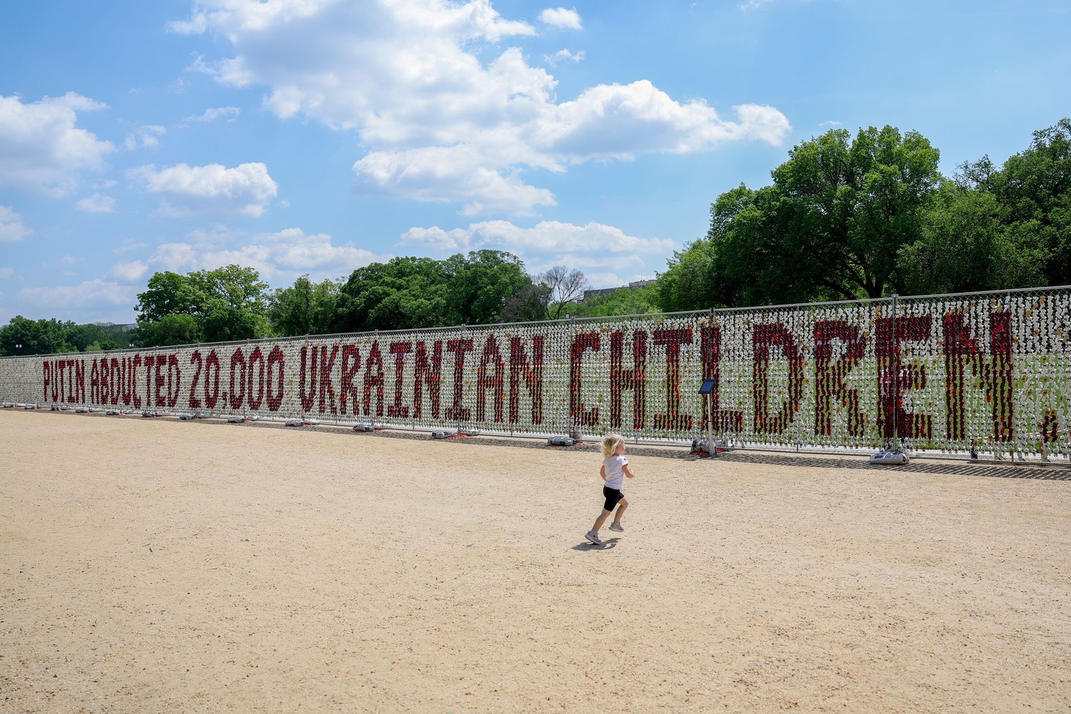 A child runs in front of an installation of 20,000 teddy bears,on the National Mall in Washington, D.C., U.S. on April 23, 2026.