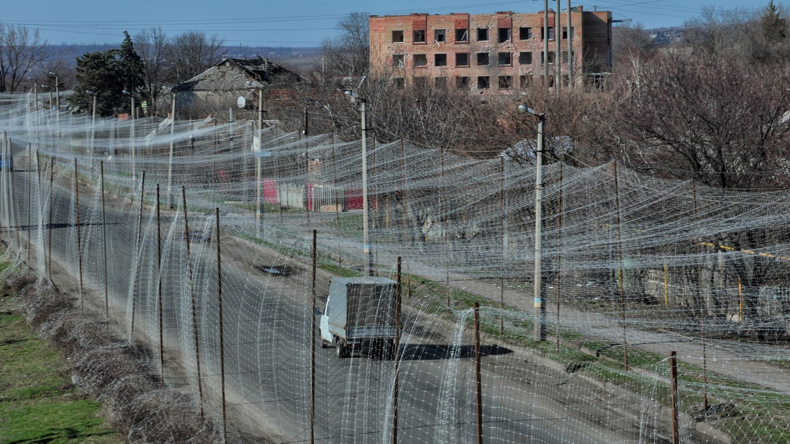 A truck drives on a road covered in anti-drone netting in Druzhkivka, Donetsk Oblast, Ukraine, on March 23, 2026.