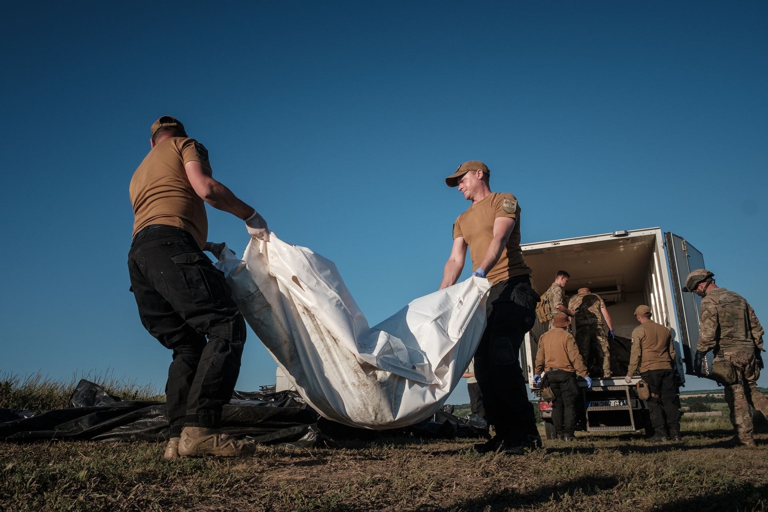 Black Tulip volunteers work to identify the remains of Russian soldiers in Donetsk Oblast, Ukraine, on June 29, 2024.
