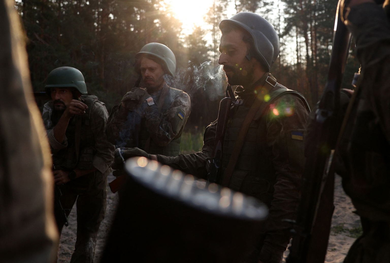 Ukrainian infantrymen of the Carpathian Sich 49th Infantry Battalion, drafted during the mobilization, smoke during training at an unspecified location near the front line in Donetsk Oblast, Ukraine, on July 19, 2024.