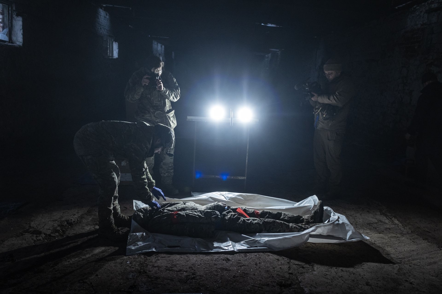 Volunteers work to identify the remains of a Russian soldier recovered from the frontline in Donetsk Oblast, Ukraine, on Jan. 11, 2026.