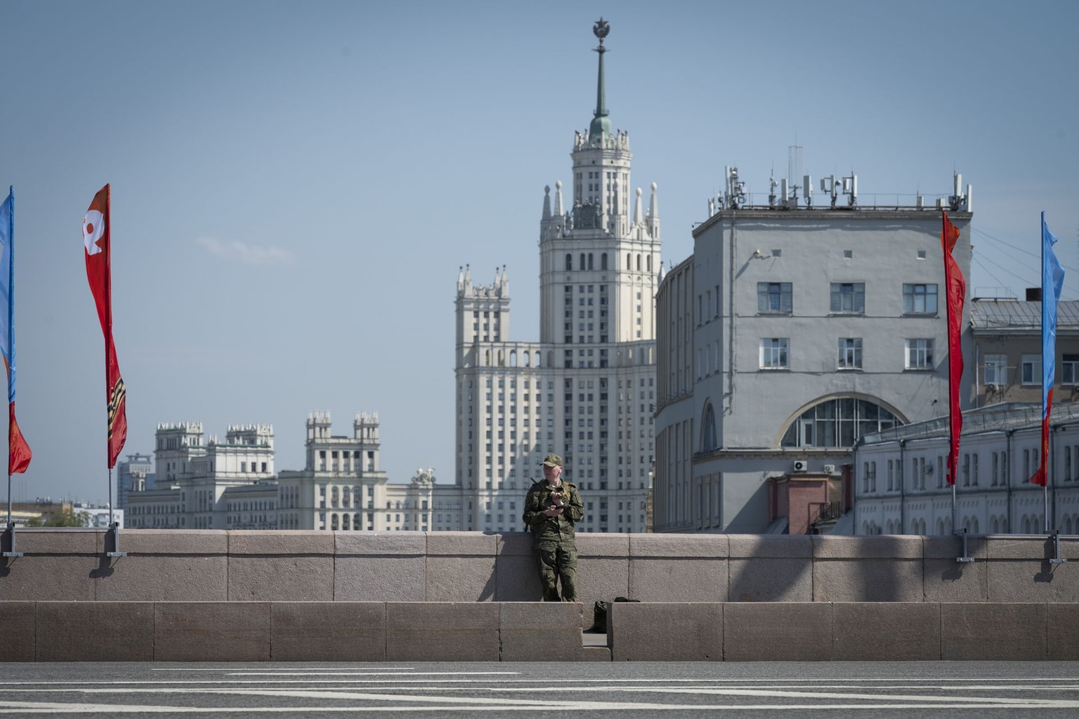 A man in a military uniform checks his mobile phone on a street in Moscow, Russia, on May 6, 2026.