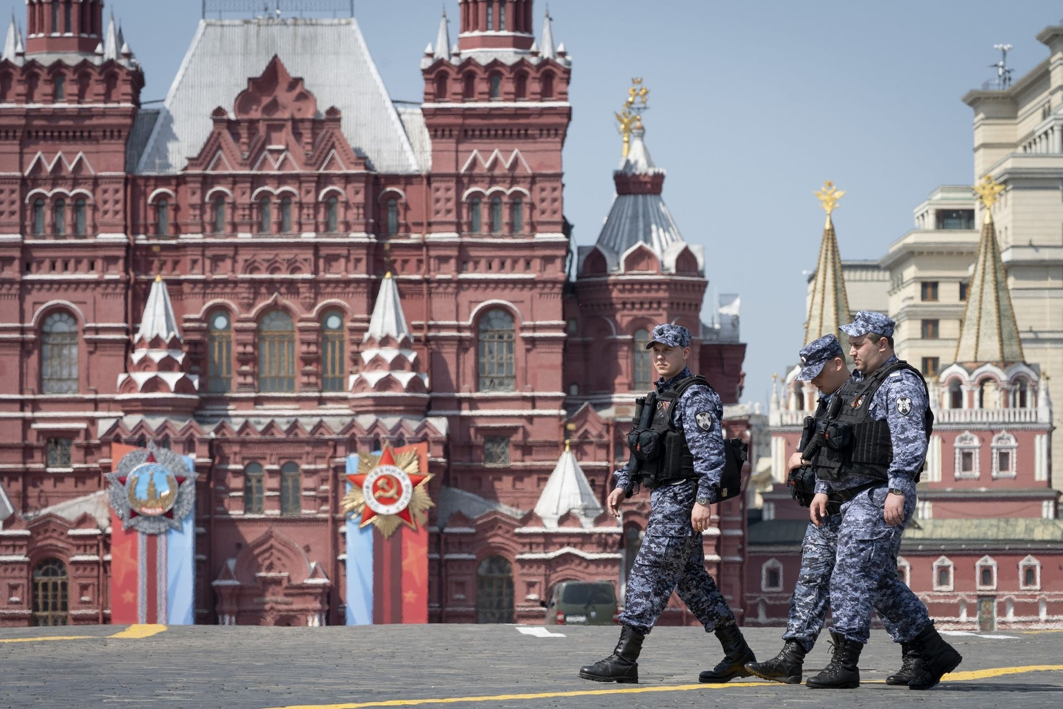 Russian National Guard officers walk across Red Square decorated for the Victory Day military parade in Moscow, Russia, on May 6, 2026.