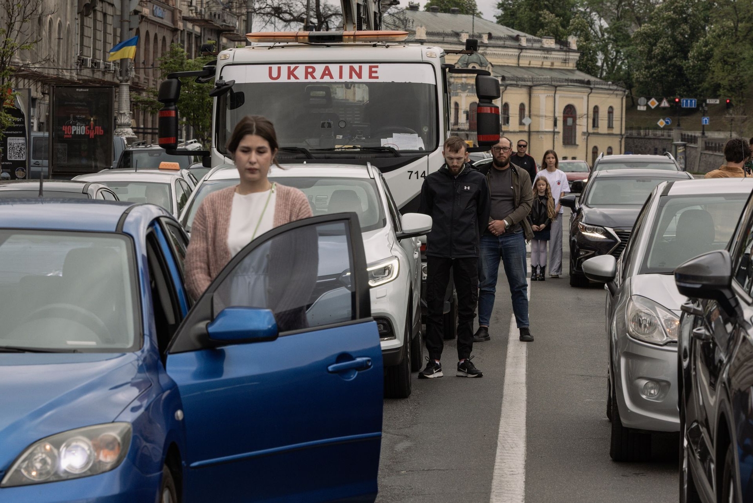 People stop their cars to observe a one-minute silence daily at 9:00 a.m. to honor soldiers killed in the Russia-Ukraine war, a ritual initiated by President Volodymyr Zelensky in 2022, in Kyiv, Ukraine, on May 9, 2026.