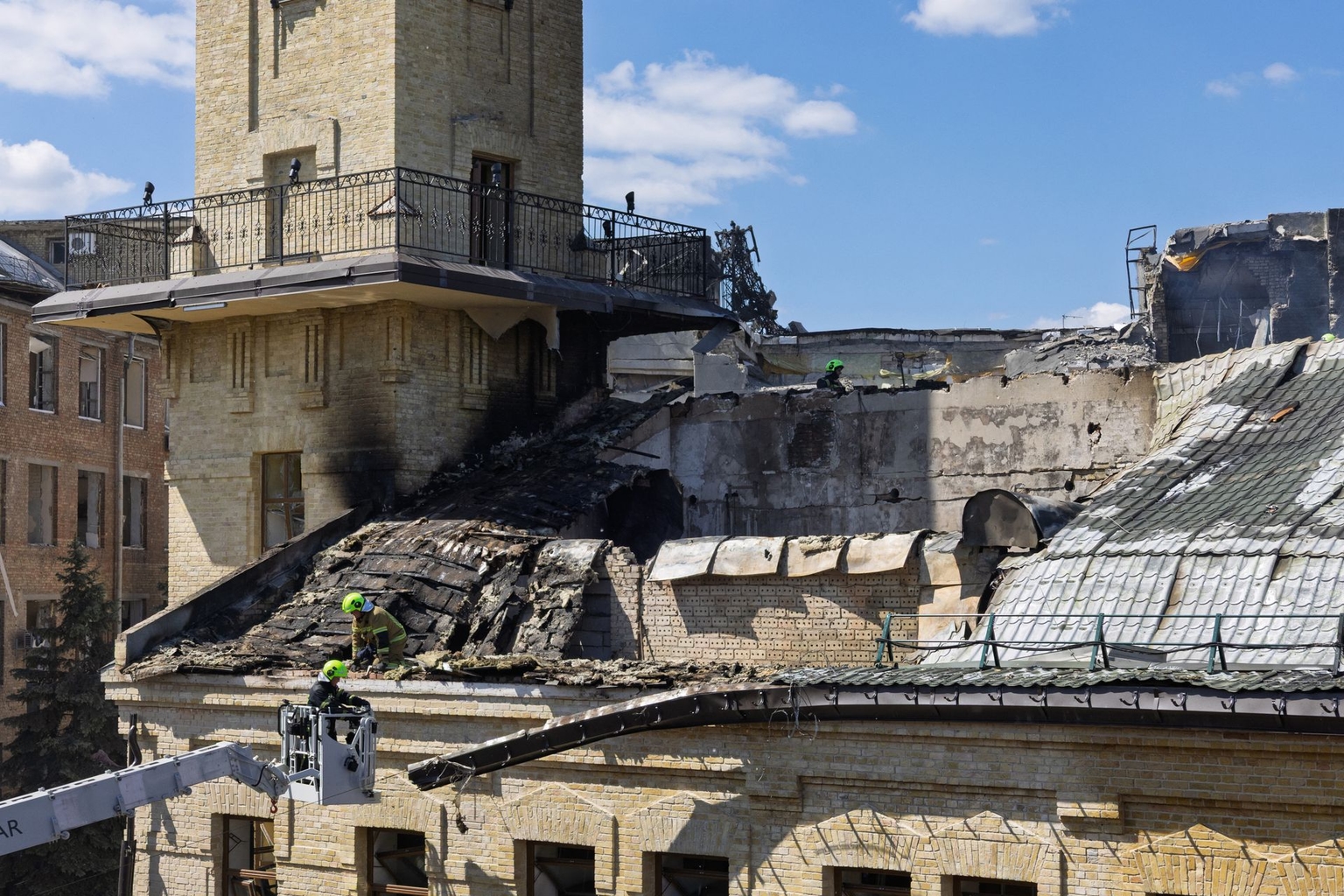Rescuers and first responders work on the roof of the National Chornobyl Museum, heavily damaged by a Russian airstrike, in Kyiv, Ukraine, on May 24, 2026.