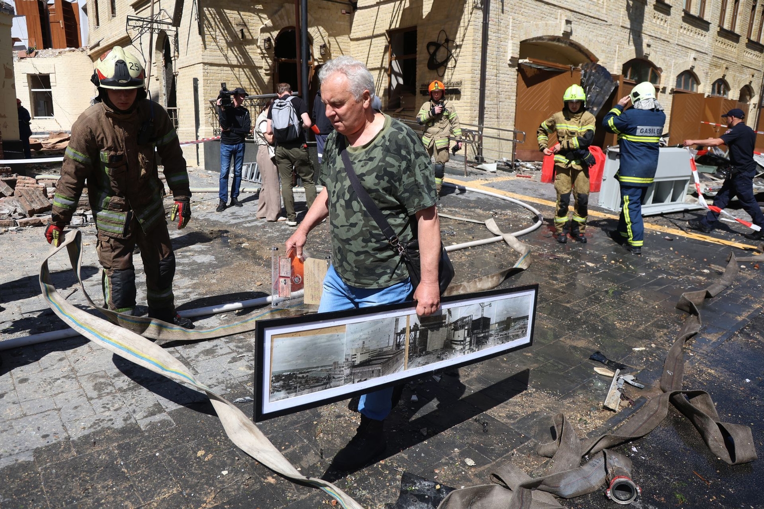 People carry surviving exhibits from the National Chornobyl Museum damaged by a Russian strike in Kyiv, Ukraine, on May 24, 2026.