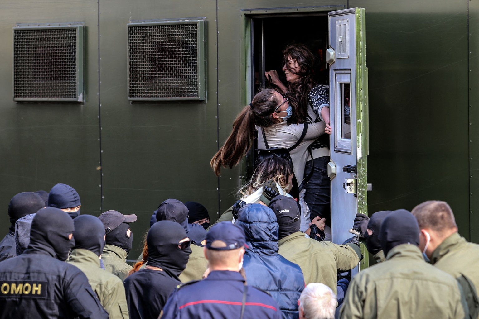 Law enforcement officers detain women during a rally protesting the presidential election results in Minsk, Belarus, on Sept. 12, 2020.