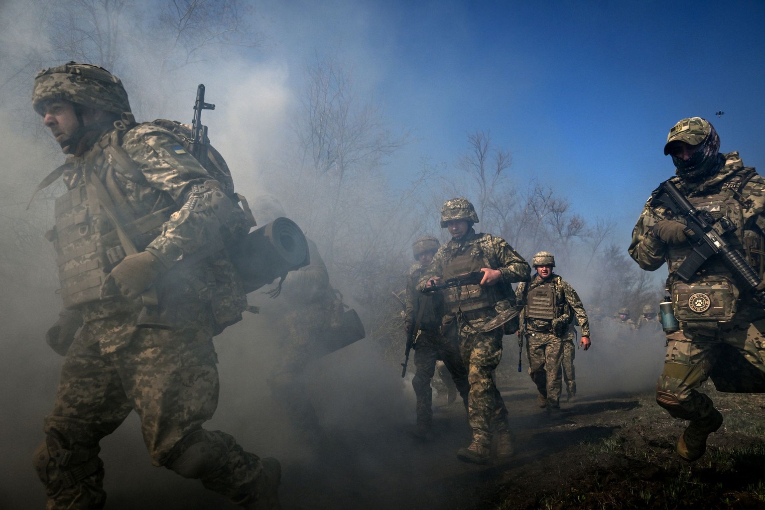 Recruits, supervised by instructors, cover a distance on Day Zero of Basic Military Training at the 118th Separate Mechanized Brigade of the Ukrainian Armed Forces on April 5, 2026.