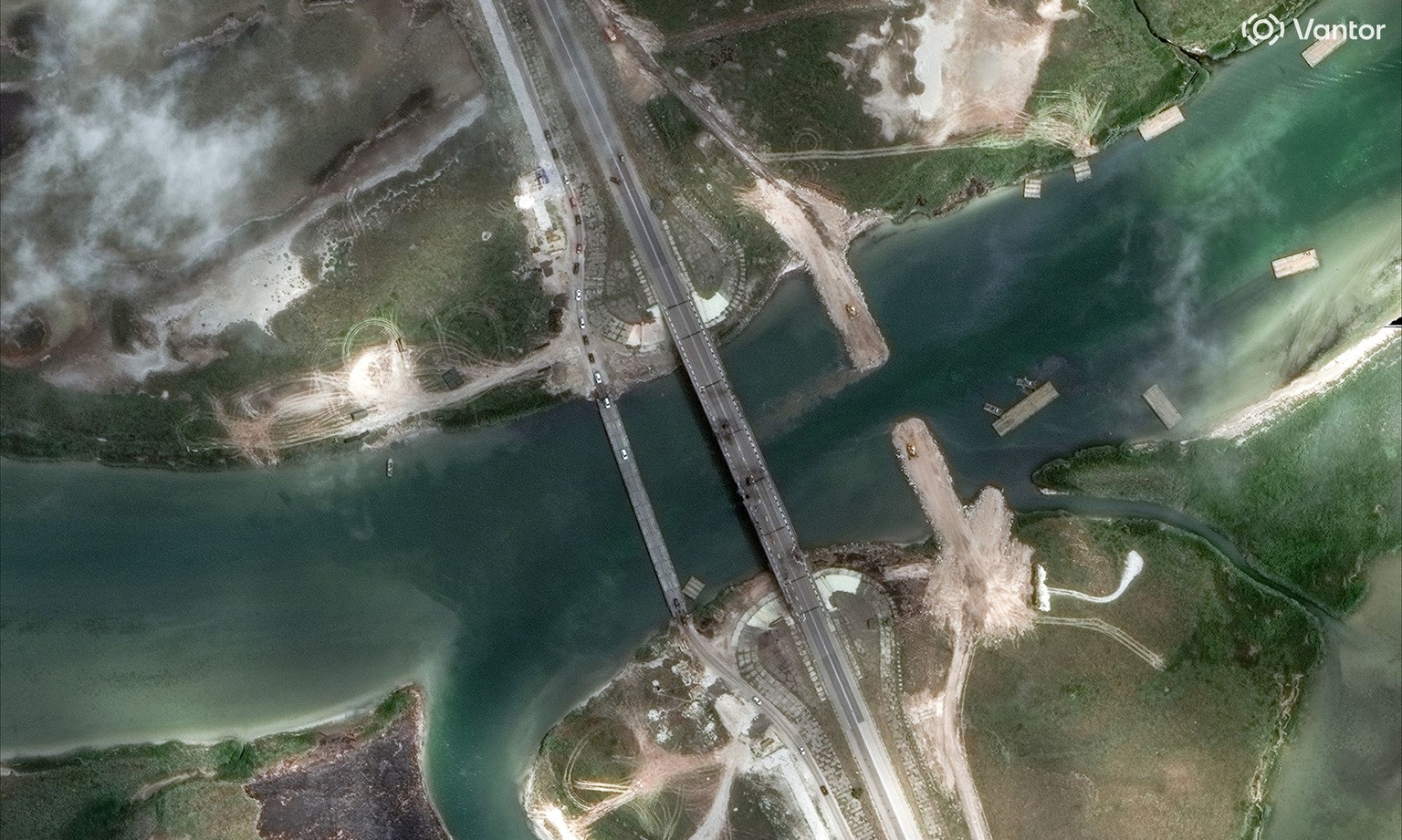 A satellite image shows the damaged Henichesk Bridge and new alternative bridges under construction over a waterway in Russia-occupied Crimea, Ukraine, on June 21, 2026.