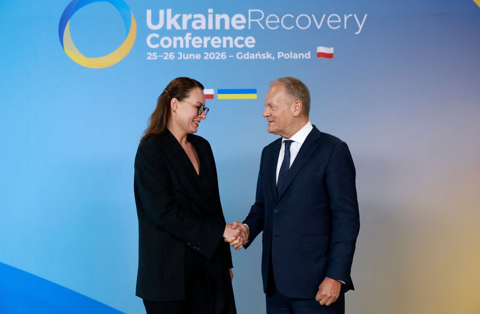 Tusk (R) shakes hands with Prime Minister Svyrydenko (R) at the URC 2026 in Gdansk, Poland, on June 25, 2026.