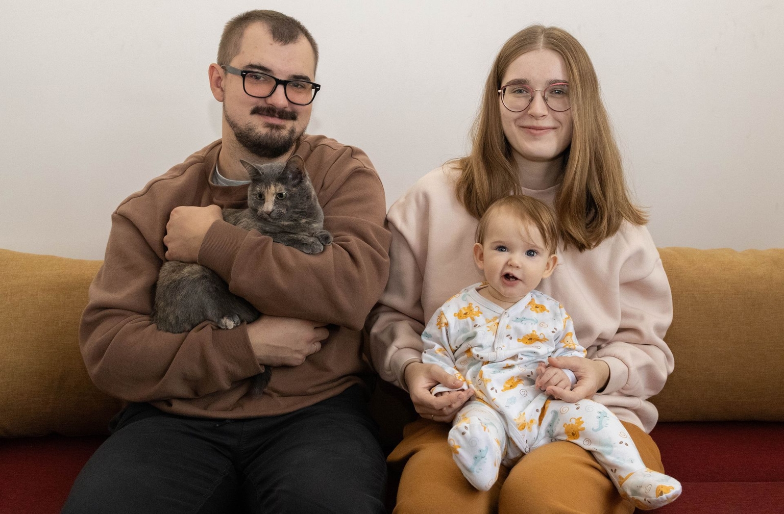 Volynets family and their rescued cat Lypka from Vysoke, Kherson Oblast, in Hostomel, Kyiv Oblast, Ukraine, on Sept. 28, 2025.