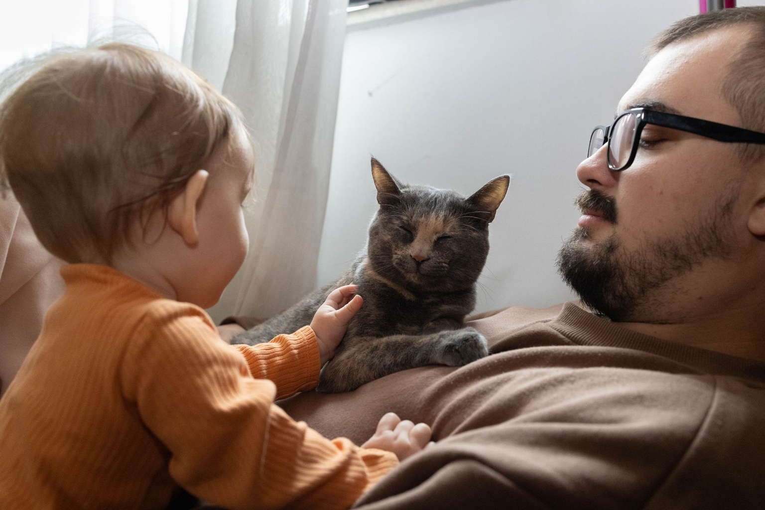 Maksym Volynets, his daughter Melania, and cat Lypka in Hostomel, Kyiv Oblast, Ukraine, on Sept. 28, 2025.