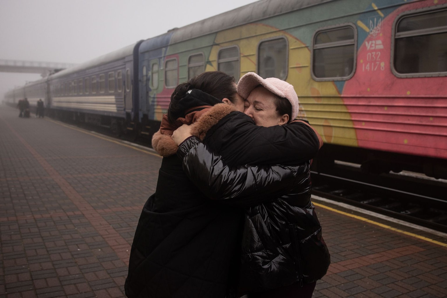 Friends hug after a train arrives in Kherson, Ukraine, on Nov. 21, 2022.