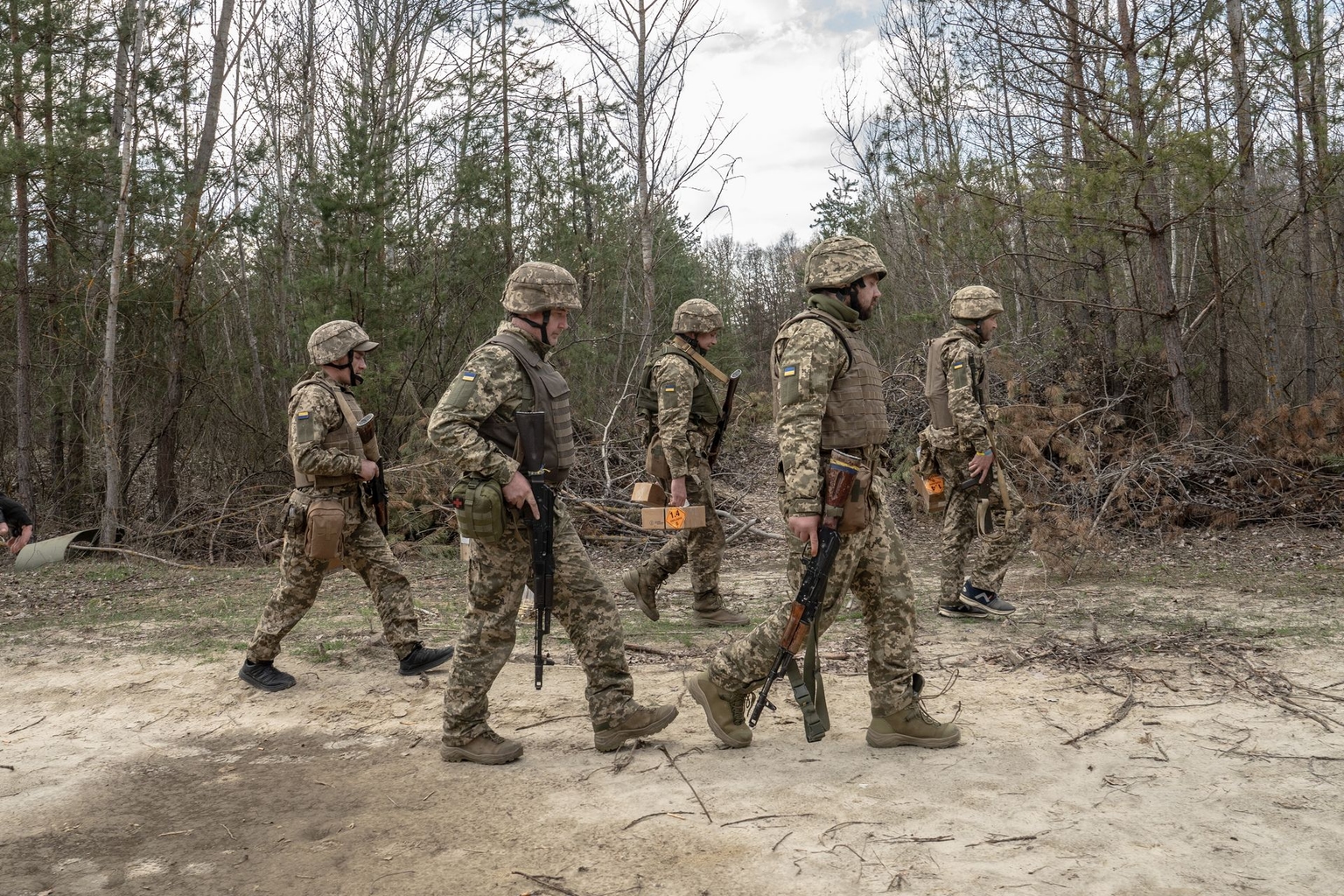 Recruits of Ukraine's 66th Mechanized Brigade walk past during a shooting exercise in Kharkiv Oblast, Ukraine, on April 2, 2026.
