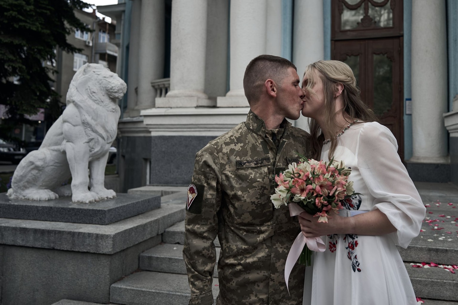 A bride and groom kiss during their wedding in Kharkiv, Ukraine, on May 18, 2024.