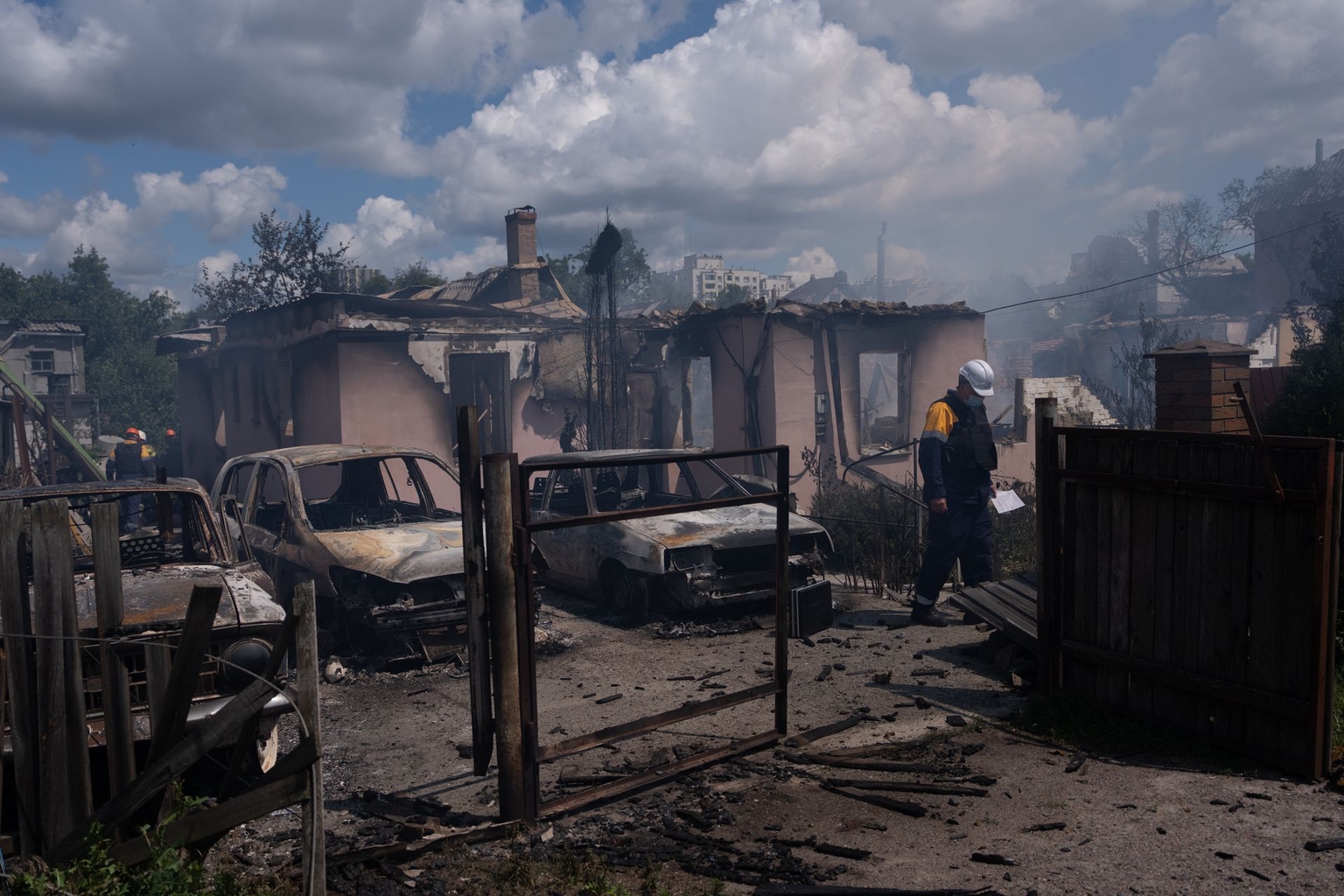A rescuer stands near cars and private houses destroyed in a Russian missile strike in Vyshneve, Kyiv Oblast, Ukraine, on July 6, 2026.