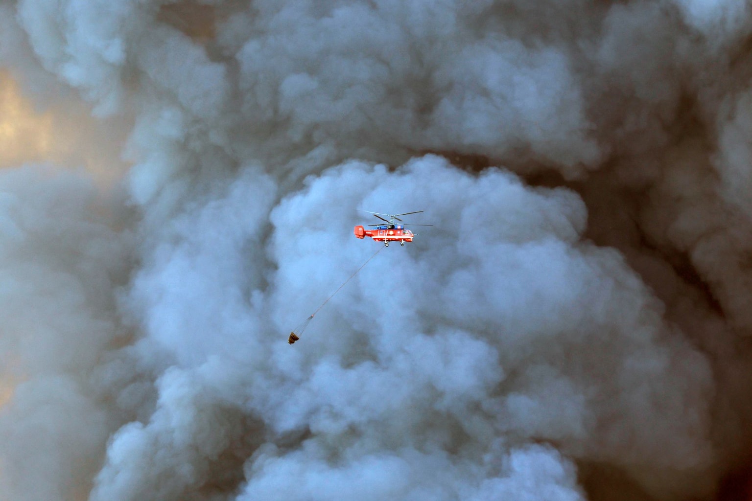 Firefighting helicopter attempts to extinguish a fire at a logistics complex in Elektrostal, Russia, on July 18, 2026.