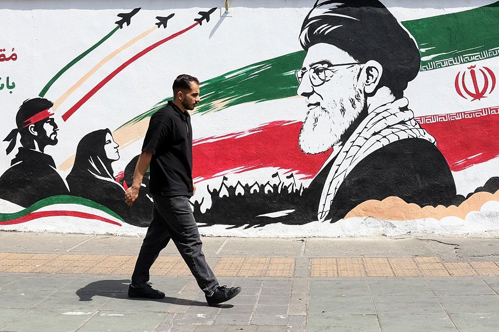 A man walks past a mural depicting late Iranian supreme leader Ayatollah Ali Khamenei in Tehran, Iran on July 24, 2026.