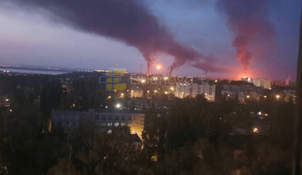 Three large columns of smoke rise in the distance